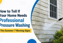 Professional pressure washing cleaning a home's exterior siding during summer.